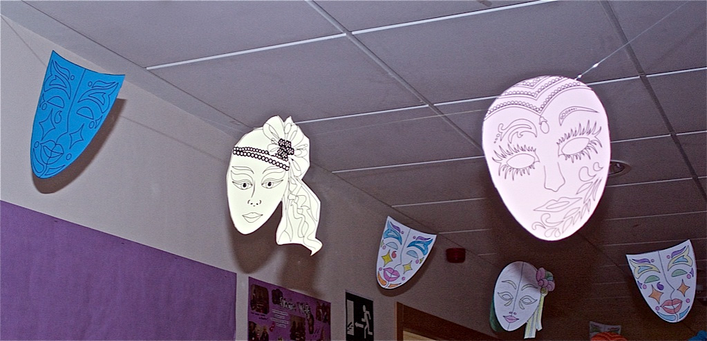The masks hanging from the ceiling have been made by the residents
